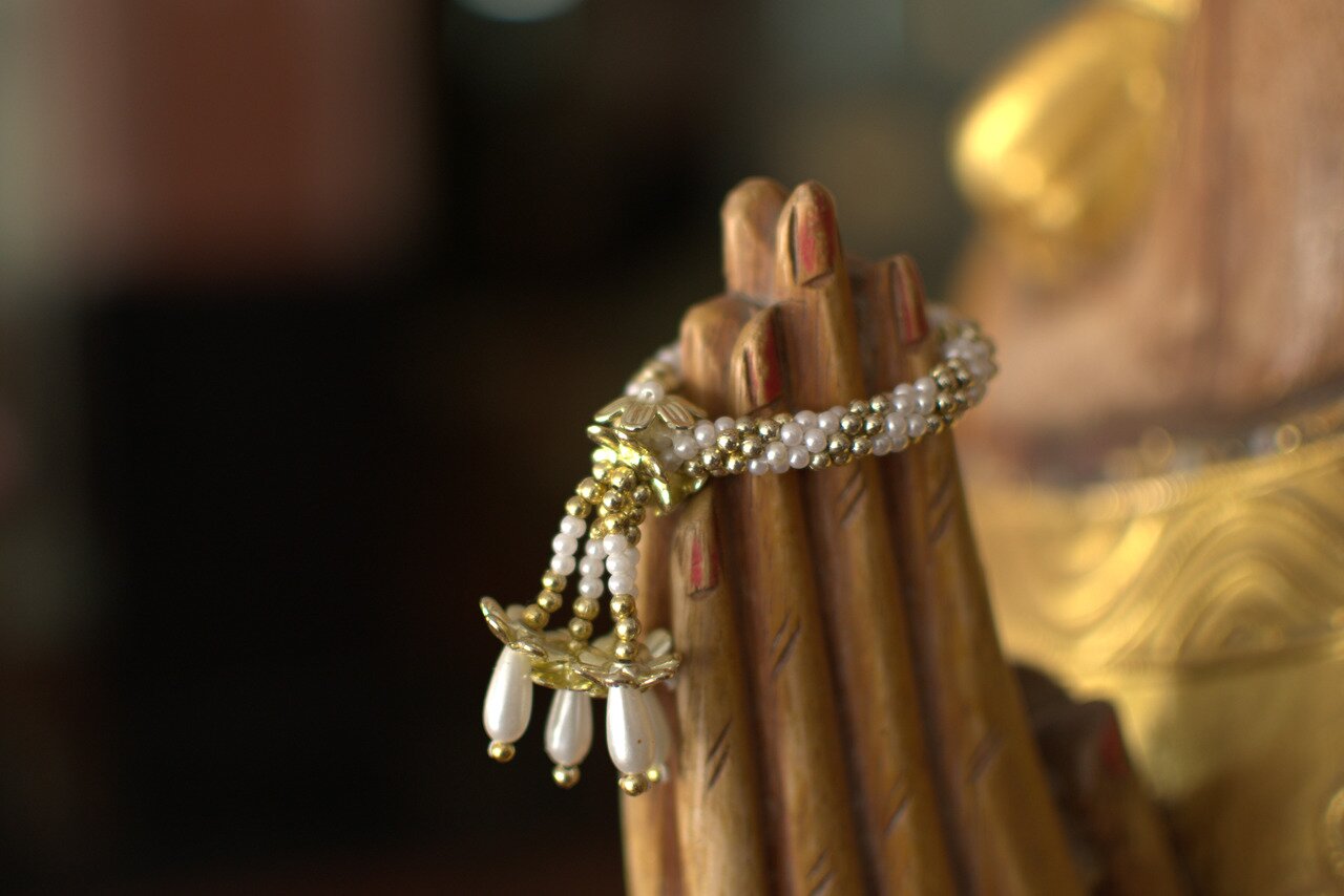 prayer bracelet and carved hands, Ayutthaya, Thailand