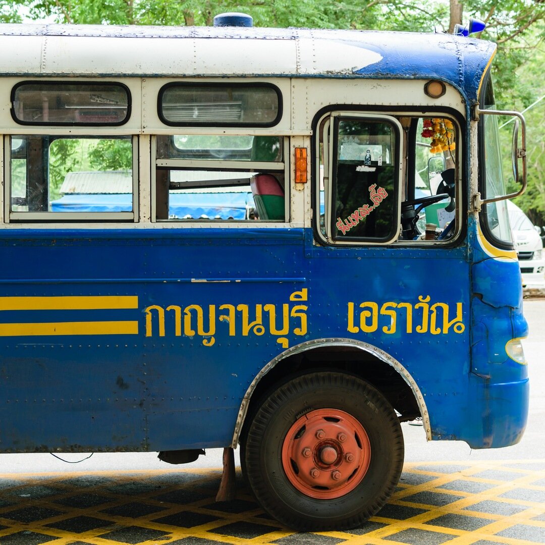 front of a small bus at Erawan National Park, Thailand